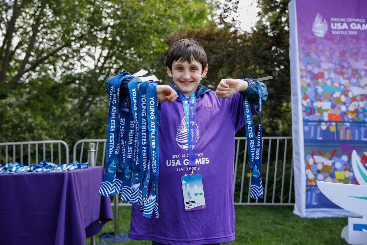Young volunteer holds lanyards
