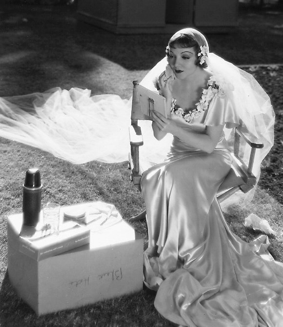 Claudette Colbert touching up her makeup on the set of IT HAPPENED ONE NIGHT
