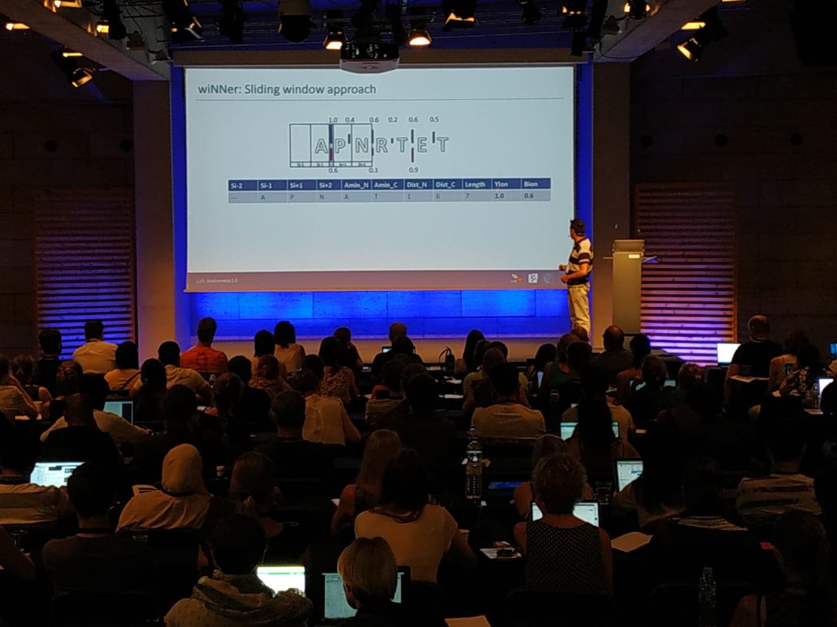 maxquant's tweet photo. Petra Gutenbrunner talking about Andromeda II and Favio Salinas about wiNNer deep learning sliding window approach #maxquantlive #MQSS2018 #maxquantgoeslive @MPI_Biochem @CRGenomica #maxquant #coxlabs #MaxquantLive https://t.co/HnzZA4lbwt