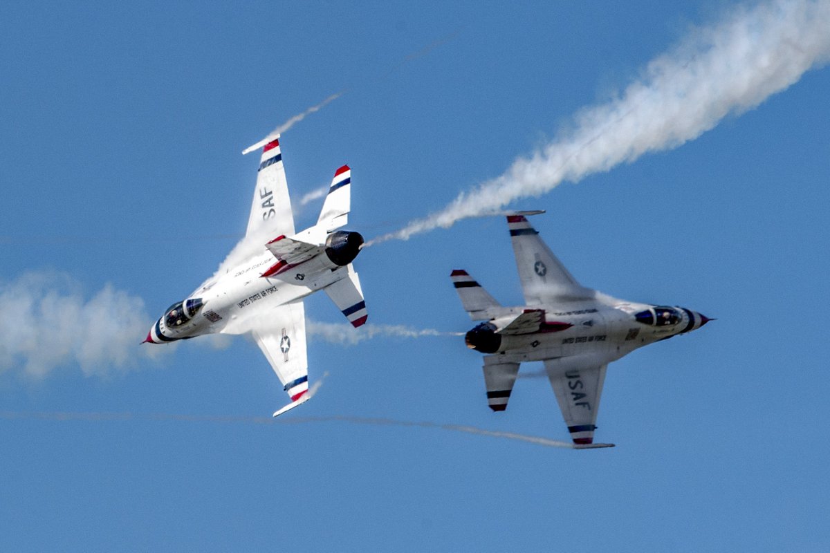 Two Air Force Thunderbirds aircraft fly close together over Alaska.