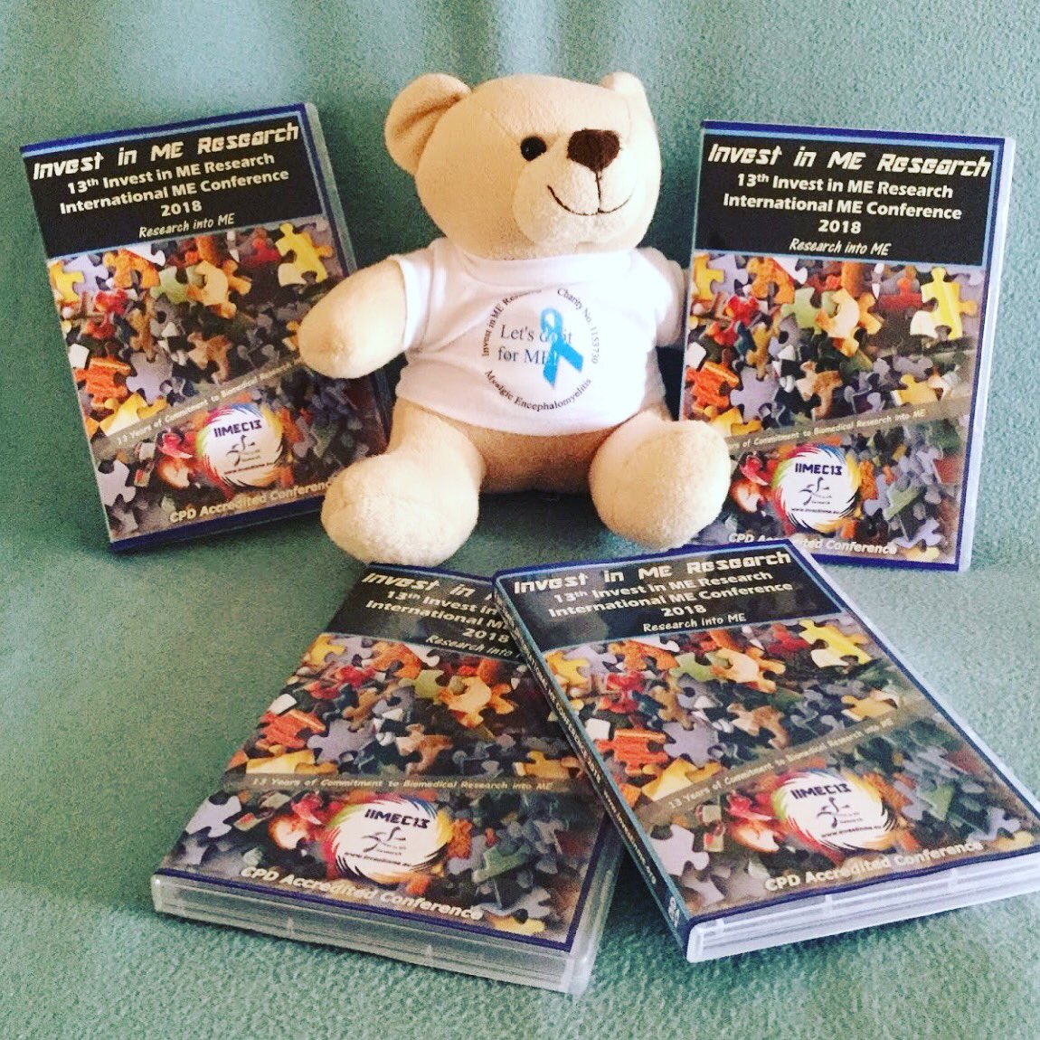 Iimer bear surrounded by this year’s conference dvds.