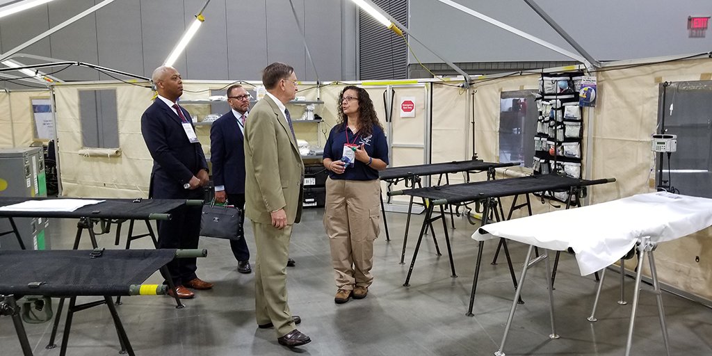 ASPRgov's tweet photo. Dr. Robert Kadlec meets NDMS team members at a
mock Base of Operations to discuss tough disaster health challenges &amp; thank
them for their service. At #NDMS2018, NDMS professionals get valuable training
to help them respond effectively, save lives &amp; protect Americans. https://t.co/oG4Fz9ls3a