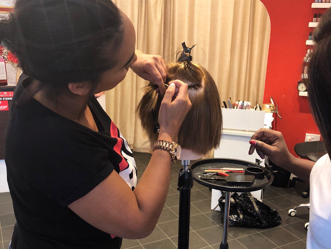 Our talented technicians teaching a client how to apply a track weave. One of the many courses available via Mane Express! ❤️ maneexpresstraining.com