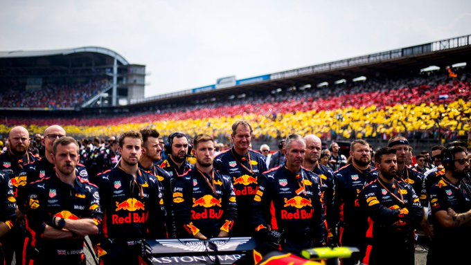 The crew stand as one on the grid ahead of the German Grand Prix