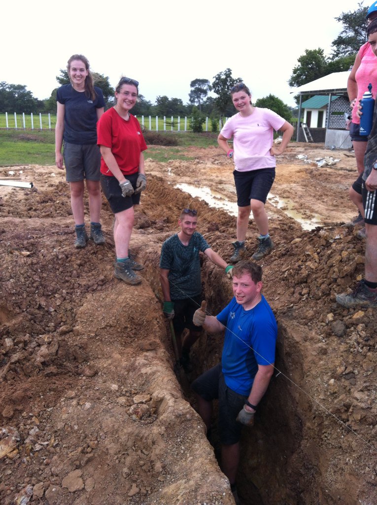 Project day 4. A chain gang was formed to get the rain out of our trench.