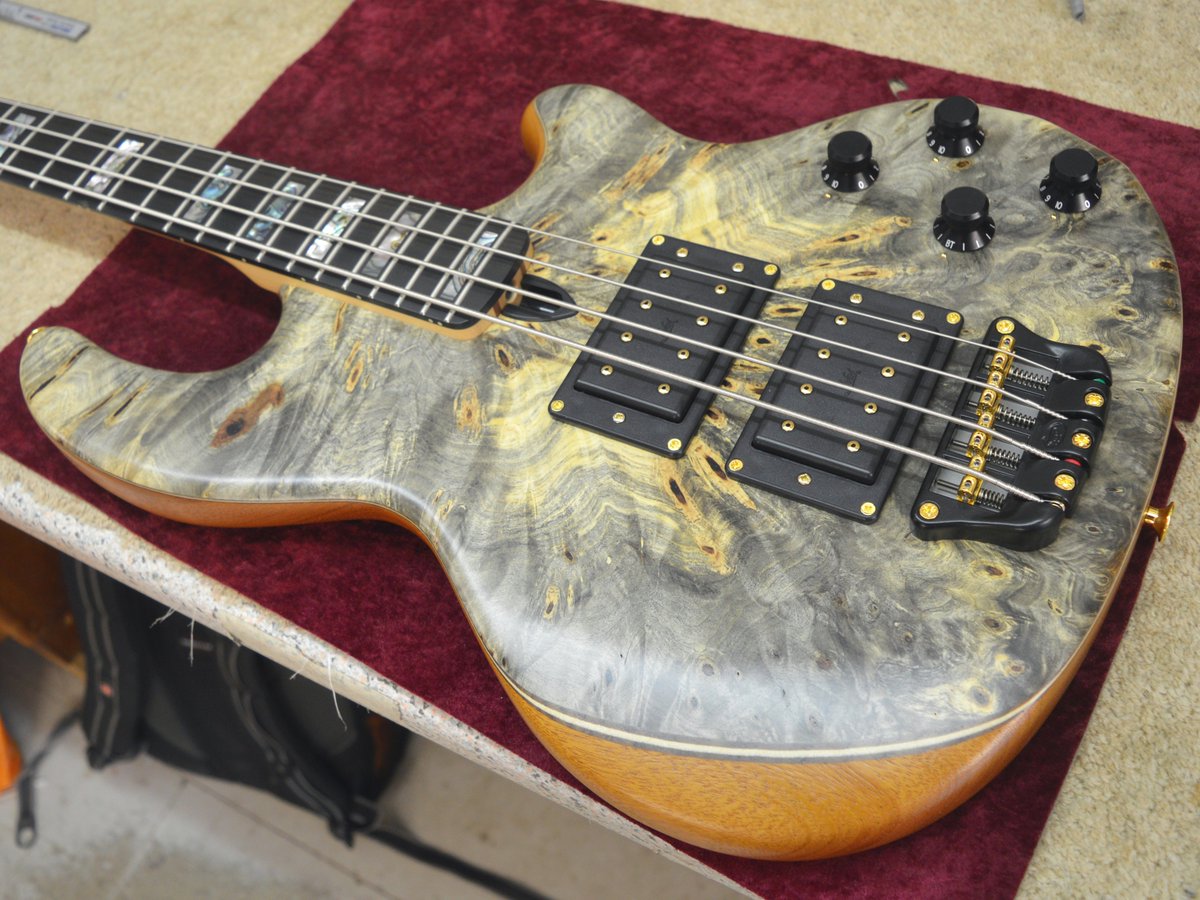 A Buckeye Burl faced Mk2 with triple body veneers, Mexican green abalone fingerboard inlays, and gold hardware.