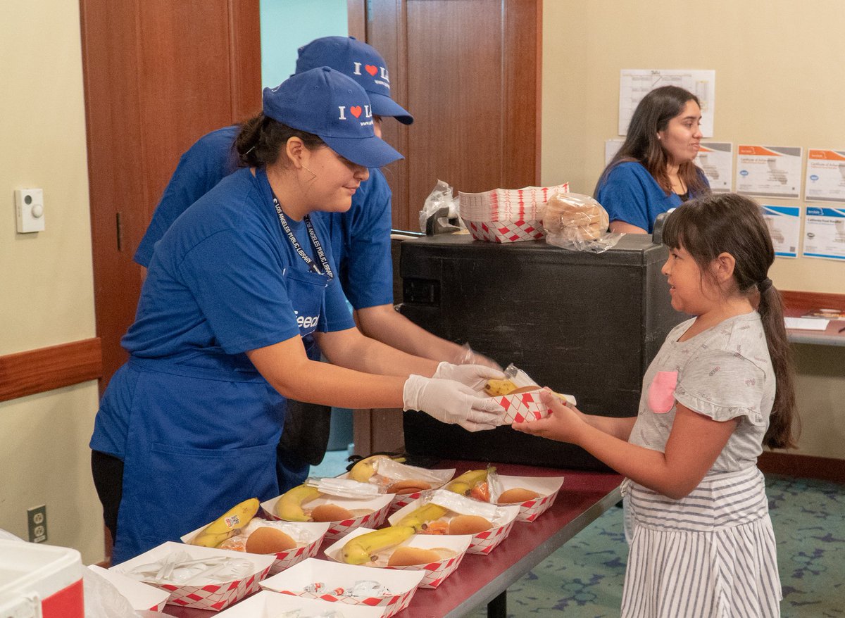 child being served lunch at the library