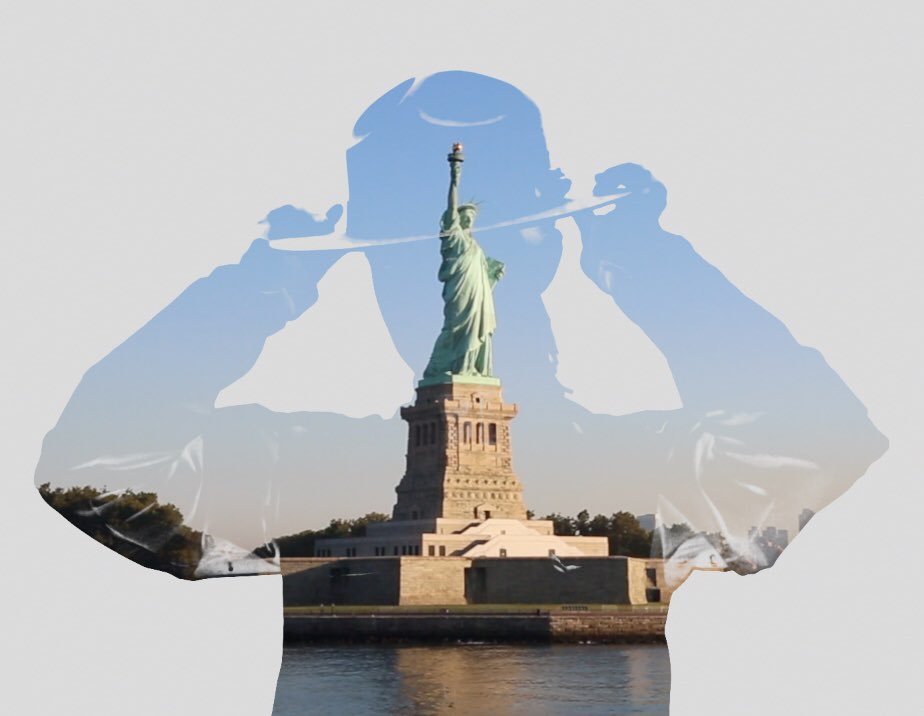 The silhouette of a Park Ranger with the Statue and pedestal within.