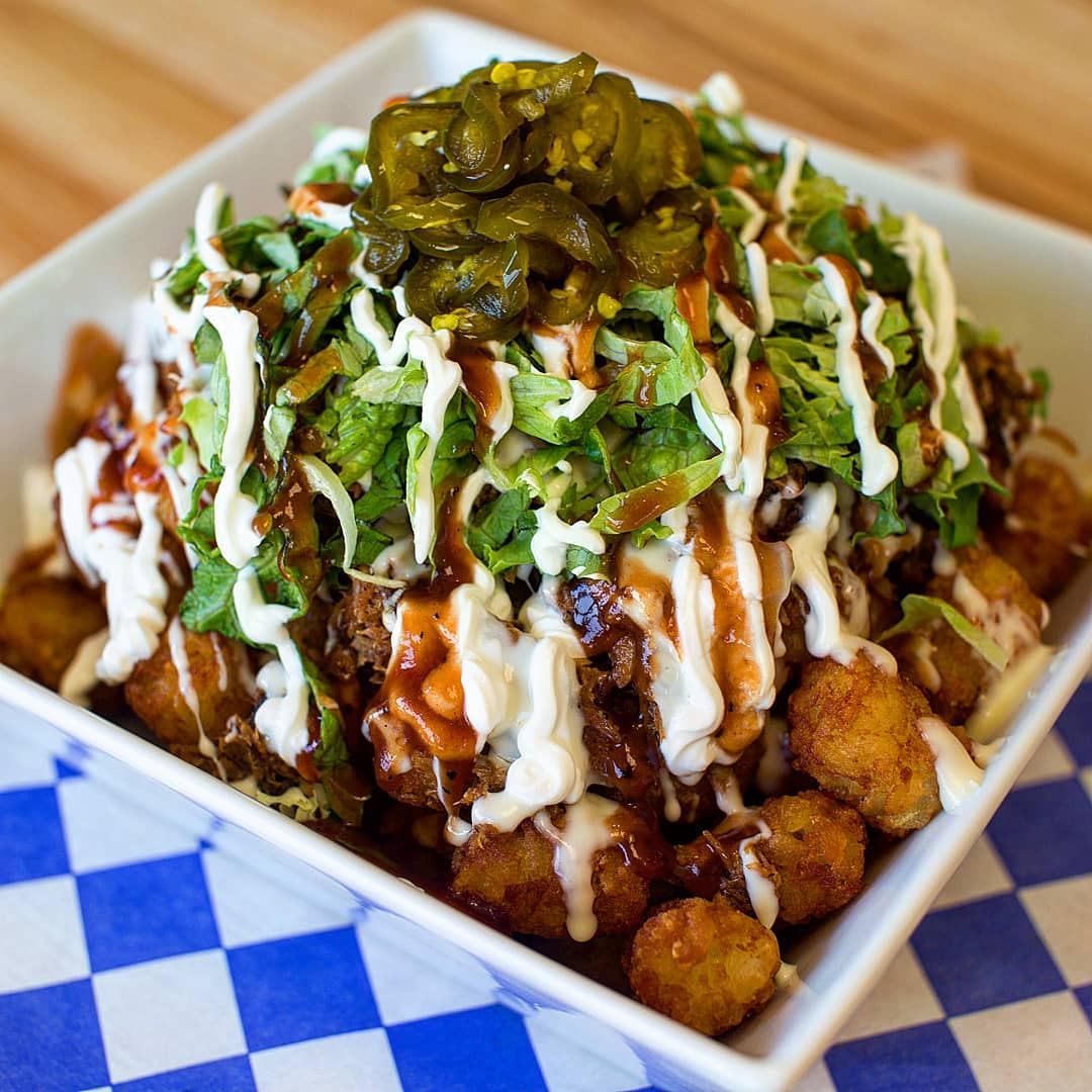 Truck Norris will be joining us at Decatur Celebration this year with their loaded tot-chos: crispy tots covered in slow smoked pulled pork smothered in Code 3 Spices BBQ sauce, white queso, lettuce, grilled corn, sour cream, &amp; candied jalapenos. Basically, YUM! PC: Truck Norris