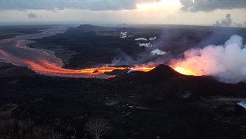 Fissure 8 continues to be the primary erupting vent on Kīlauea's lower East Rift Zone, although several other fissures were observed steaming during this morning's overflight. This aerial image shows the fissure 8 vent (near center), channelized flow, and distant ocean entry (upper right).