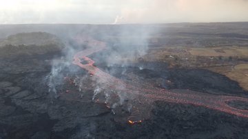 Continuation of the main fissure 8 channel, which is now flowing on the west side of Kapoho Crater (left) and was entering the ocean about 300 meters west of the Kapoho ocean entry this morning (steam plume in far distance).