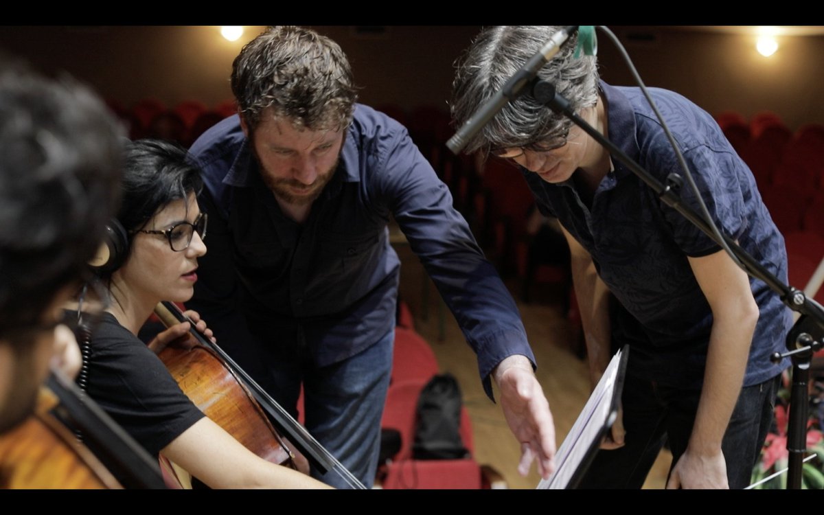 Gemsartists's tweet photo. Adam Cullen conferring with the conductor during his recording at our GEMS Christopher Young Film Scoring Program Spain. #JoseVinader #JuanjoMolina #FrancescoMenini #soundtrackfest #filmscoring #summerprogram #ImChrisYoung #Mad4Strings #orchestration #composer https://t.co/syFjNcO24B