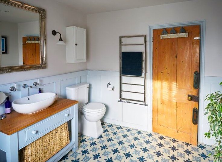 Blue and wood make for a calm bathroom. Also, how pretty are these titles?!