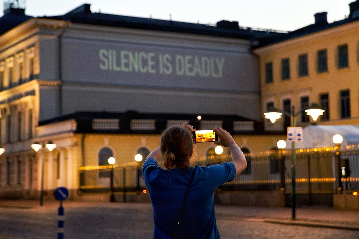 HRC’s message projected onto the side of the Presidential Palace in Helsinki, Finland, condemning Trump-Putin's silence on the human rights atrocities happening in Chechnya.