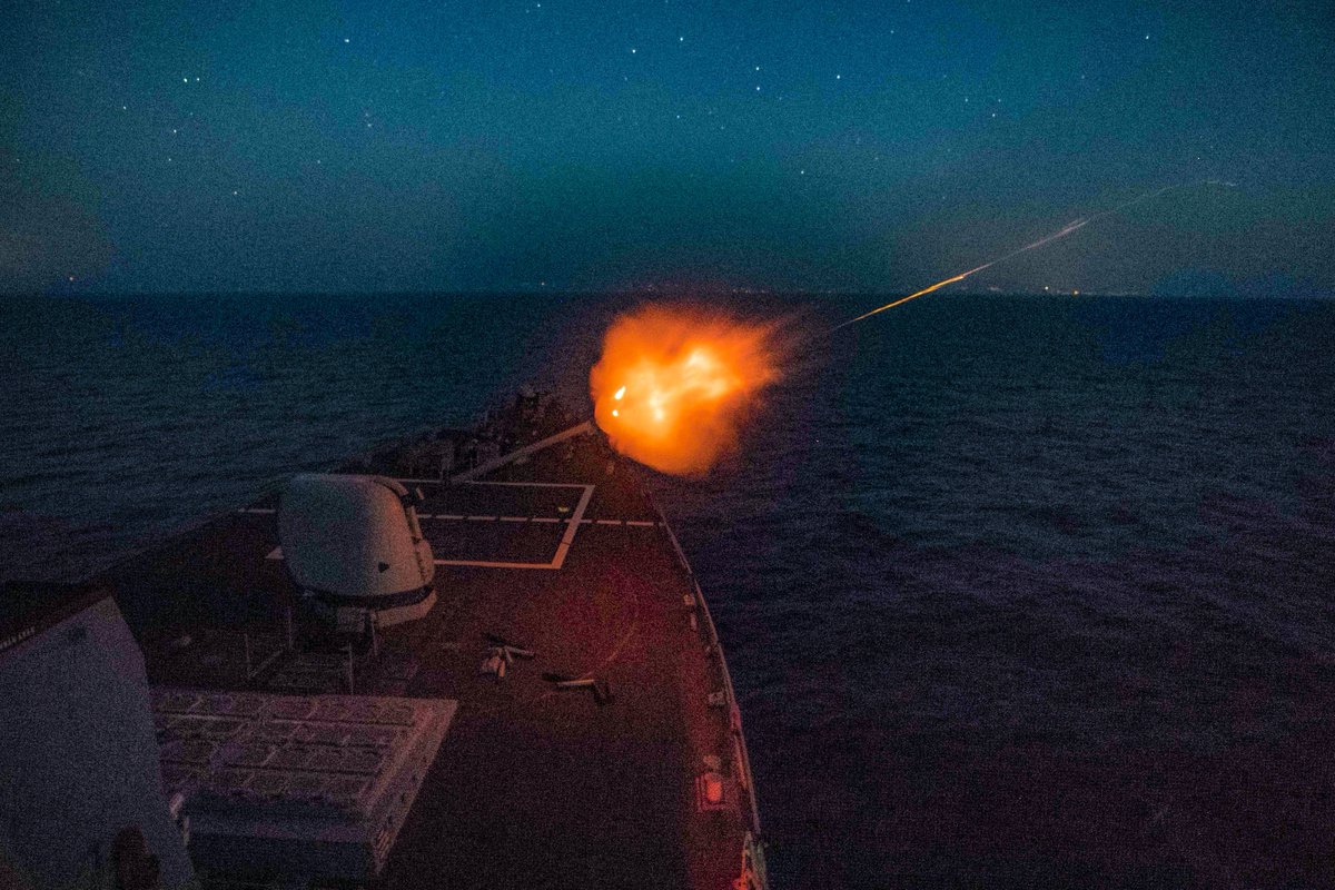 A ball of fire can be seen exiting the 5-inch gun aboard USS Porter at nightfall during an exercise in the Mediterranean Sea.