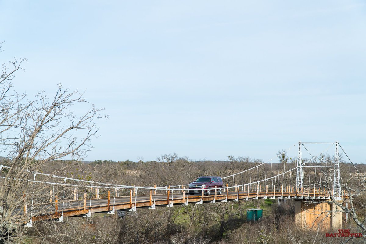 ChetTripper's tweet photo. Daily Day Trip: This historic #RegencyBridge outside of @VisitSanSaba built in 1939 is the last wooden suspension bridge you can drive across in Texas. It's a long and thrilling ride -- you can actually feel the bridge swaying underneath your tires! https://t.co/9CfIEysSGR
