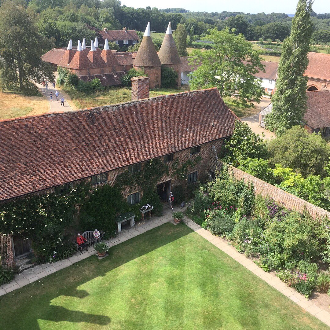 TweedleberryUK's tweet photo. On the road, #tweedyted is enjoying the rustic, romantic delights of #Sissinghurst Castle Gardens, the home of Vita Sackville-West. Impressive oast house chimneys &amp; a fabulous view from the top of the gate house. A little rain wouldn’t go amiss but lovely anyway! @nationaltrust https://t.co/GiEoa1zZRA