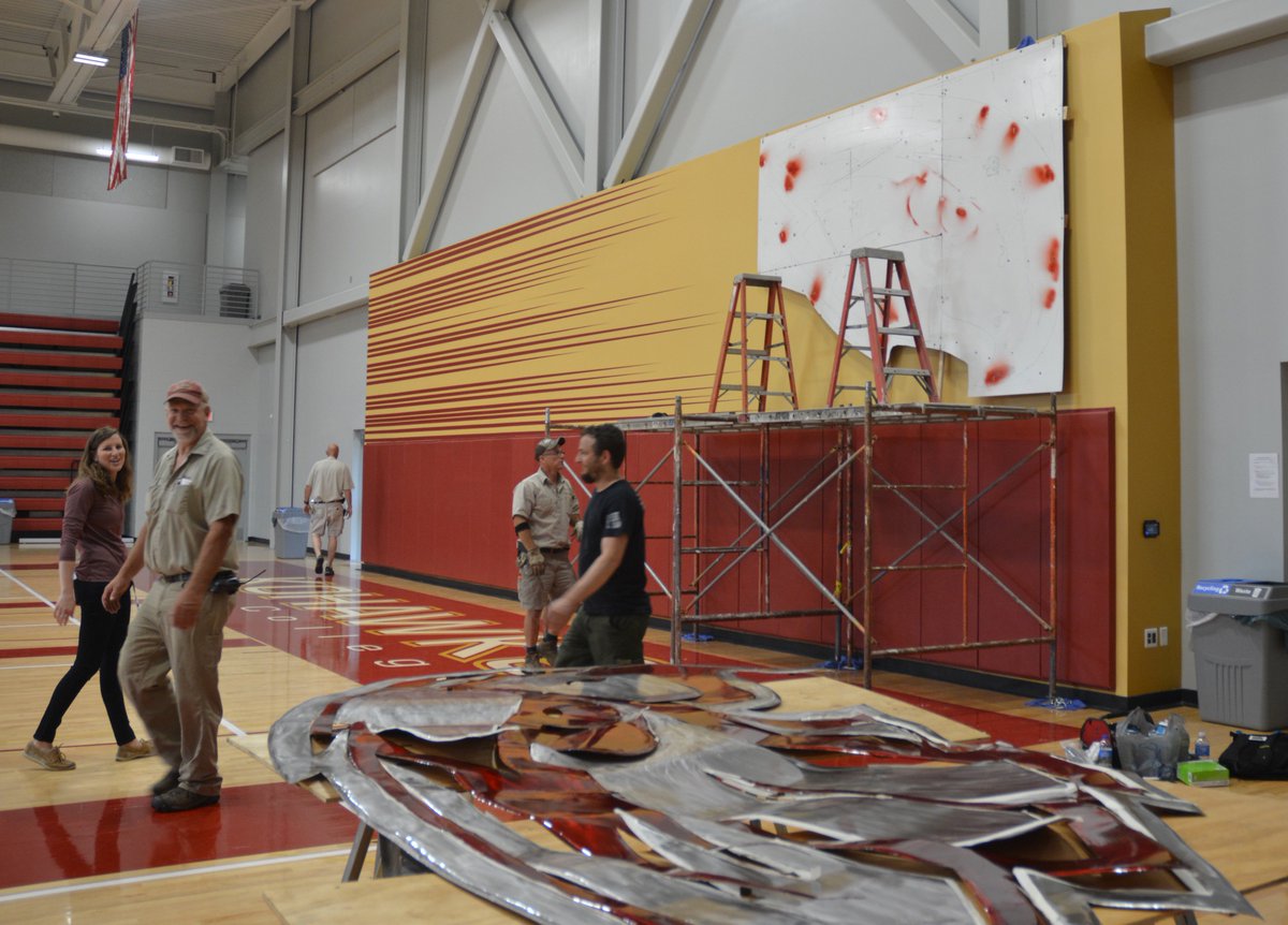 CoeCollege's tweet photo. Kohawk spirit will soar when students, faculty and fans see the new crimson and metal sculpture that has been installed in Kohawk Arena. Local artist, Josh Baker, created the custom piece that will maintain a watchful eye over Kohawk events. #KohawkEnhancements https://t.co/RAlmj5sjWu
