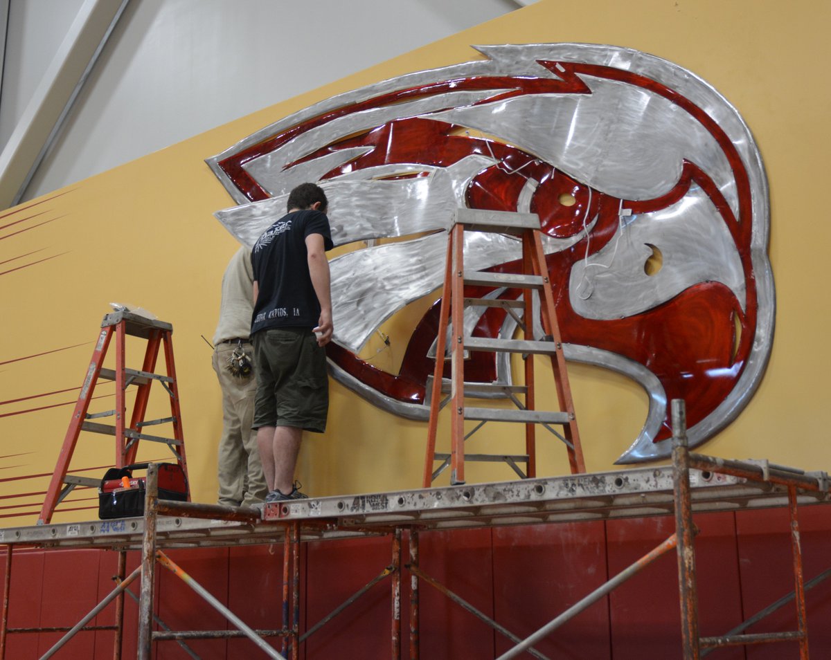 CoeCollege's tweet photo. Kohawk spirit will soar when students, faculty and fans see the new crimson and metal sculpture that has been installed in Kohawk Arena. Local artist, Josh Baker, created the custom piece that will maintain a watchful eye over Kohawk events. #KohawkEnhancements https://t.co/RAlmj5sjWu