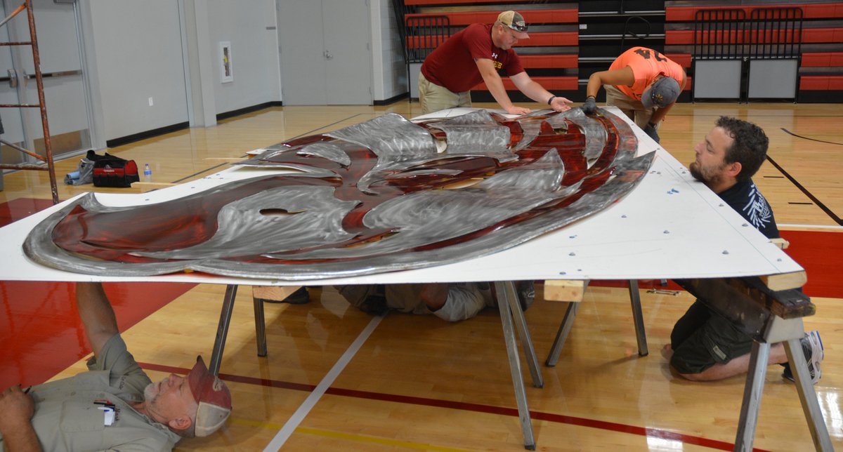 CoeCollege's tweet photo. Kohawk spirit will soar when students, faculty and fans see the new crimson and metal sculpture that has been installed in Kohawk Arena. Local artist, Josh Baker, created the custom piece that will maintain a watchful eye over Kohawk events. #KohawkEnhancements https://t.co/RAlmj5sjWu