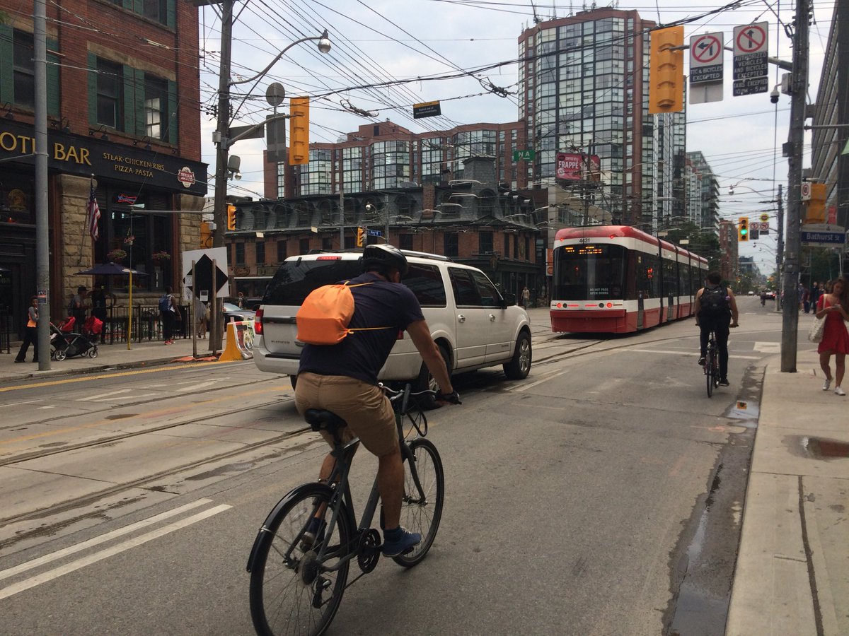 TOCitizenCop's tweet photo. 3 different types of transit at the same intersection.  Only one road user flipped me off as I set to take this photo.  Let’s guess which one it was #KingStreetPilot #Caught #BadDrivers https://t.co/dtYapdDZXK