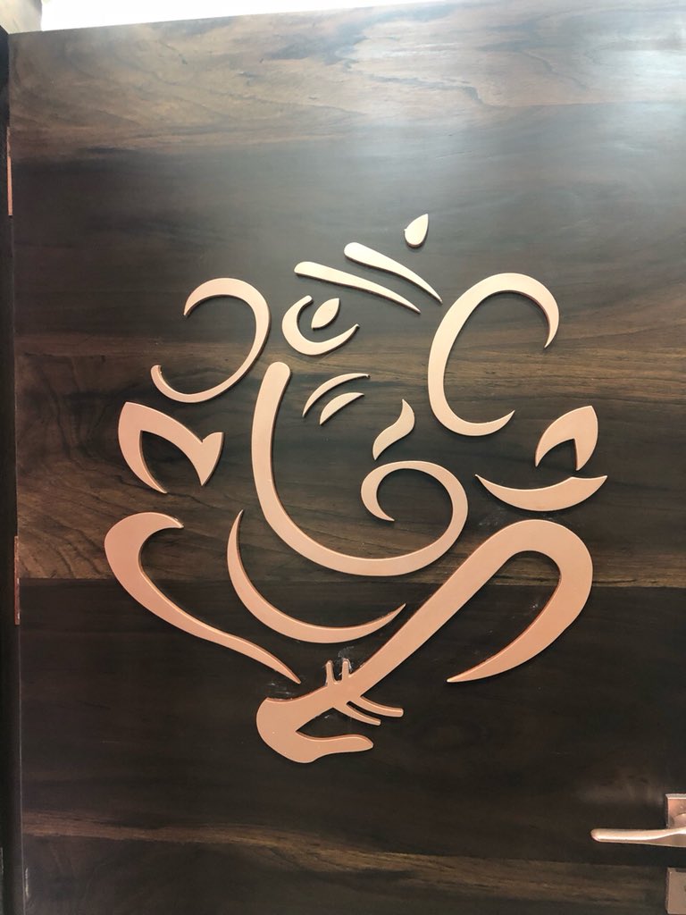 Not just a door! There is so much to it! Laser cut rose gold warli motif security grill, laser cut mdf Ganpati polished in rose gold! All this happening on dark melamine polish veneer! Every detail matters! #interiordesign #door #veneer #lovemywork