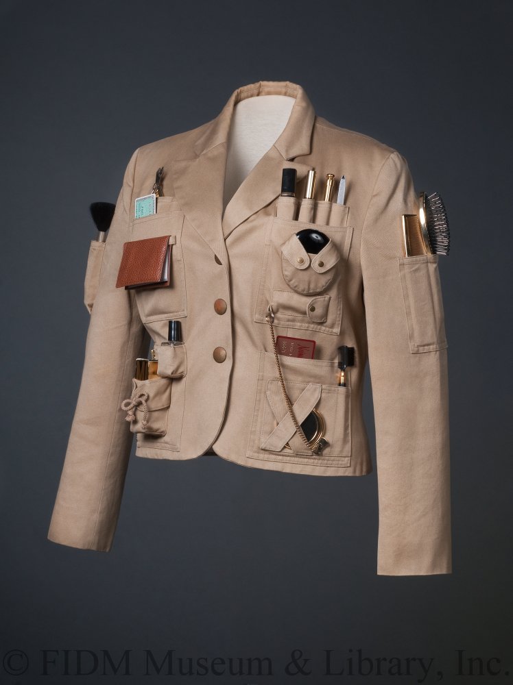 FIDMMuseum's tweet image. Our tongue-in-cheek @Moschino S/S 1991 Survival Jacket shows us that #MusTools can be beautiful! Its pockets are packed with tools for life in the urban jungle: mirror, lipstick, mascara, blush, powder, nail polish, comb, nail file, and of course, a wallet and credit cards.