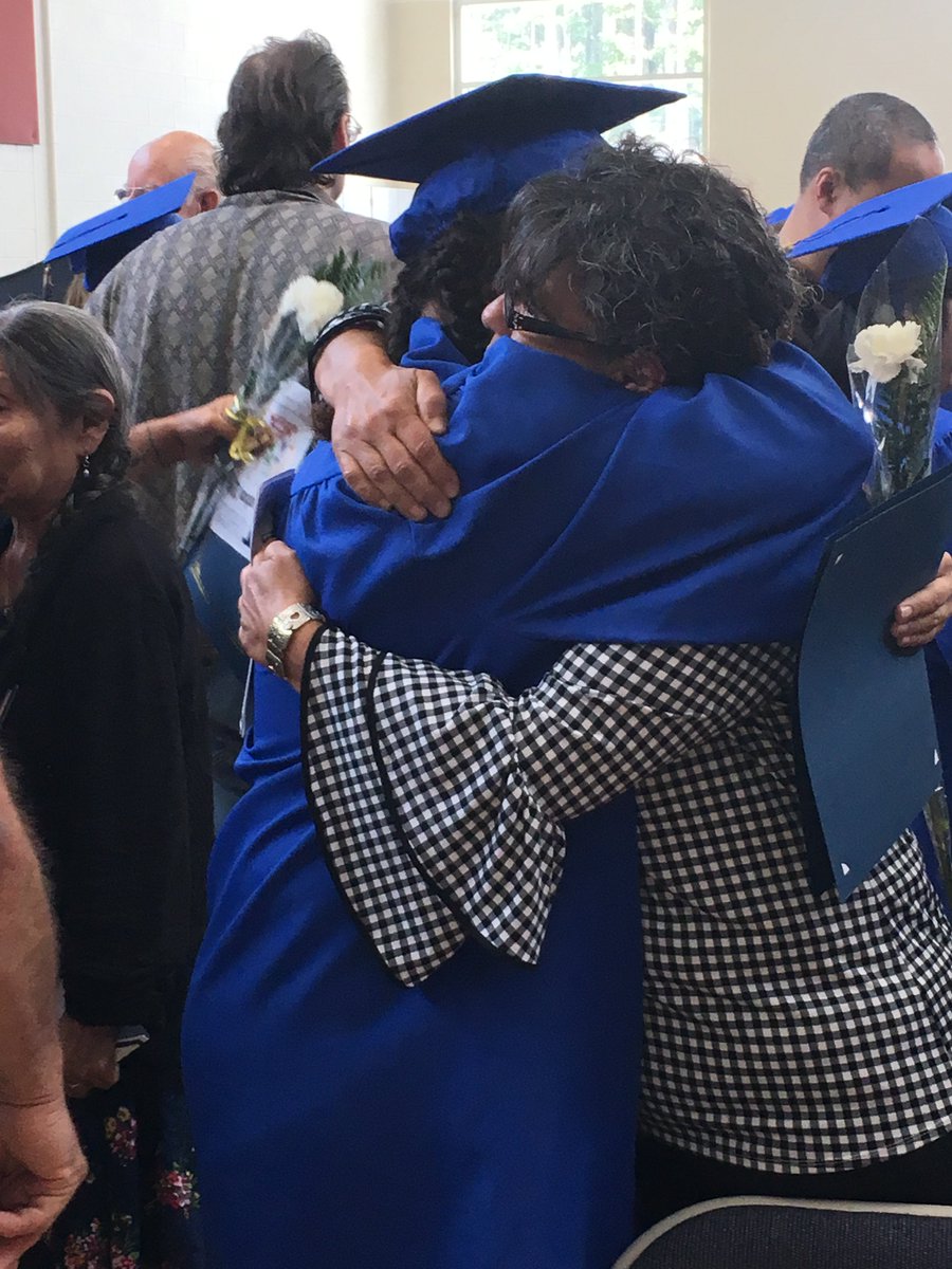 college graduate receiving a hug from a supportive family member