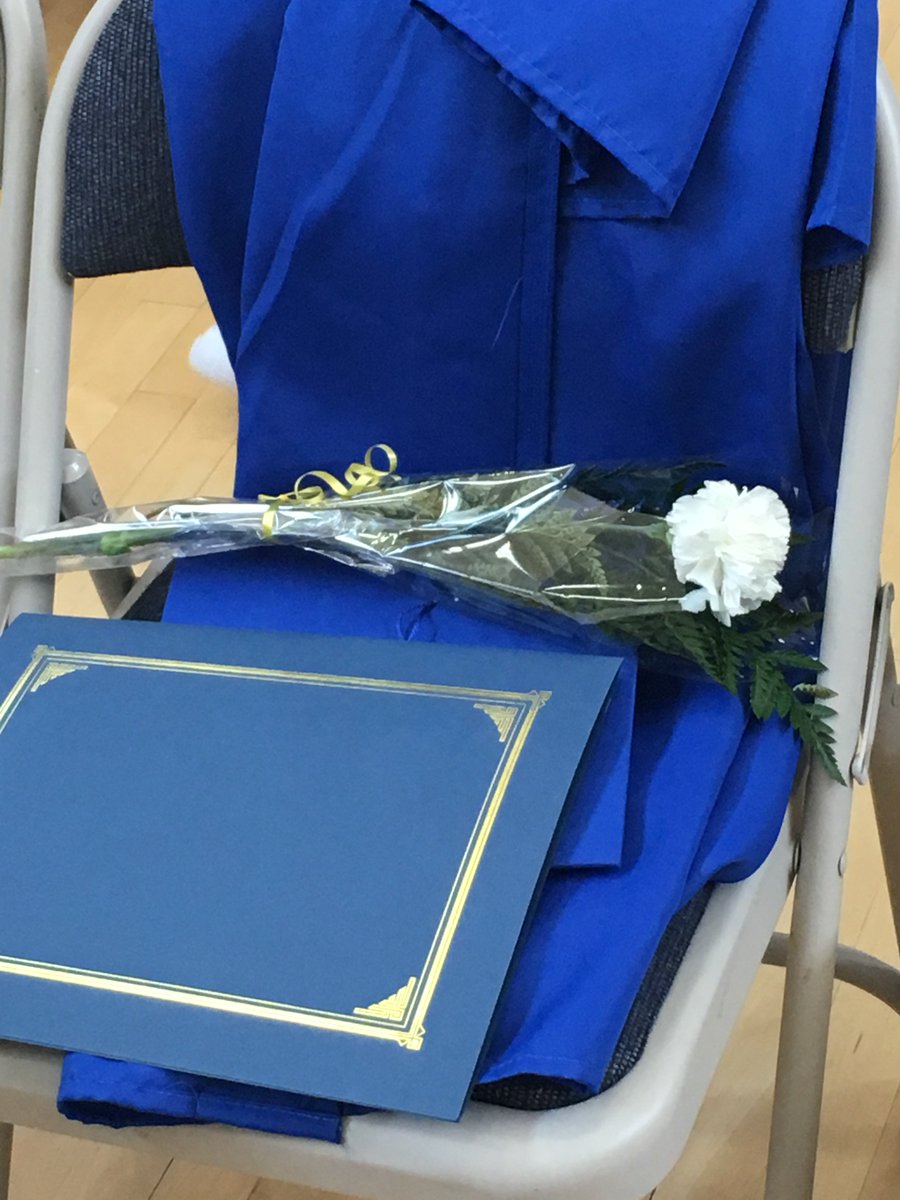 diploma, cap, gown, and flower of a recent college graduate at the Washington Corrections Center for Women in Gig Harbor