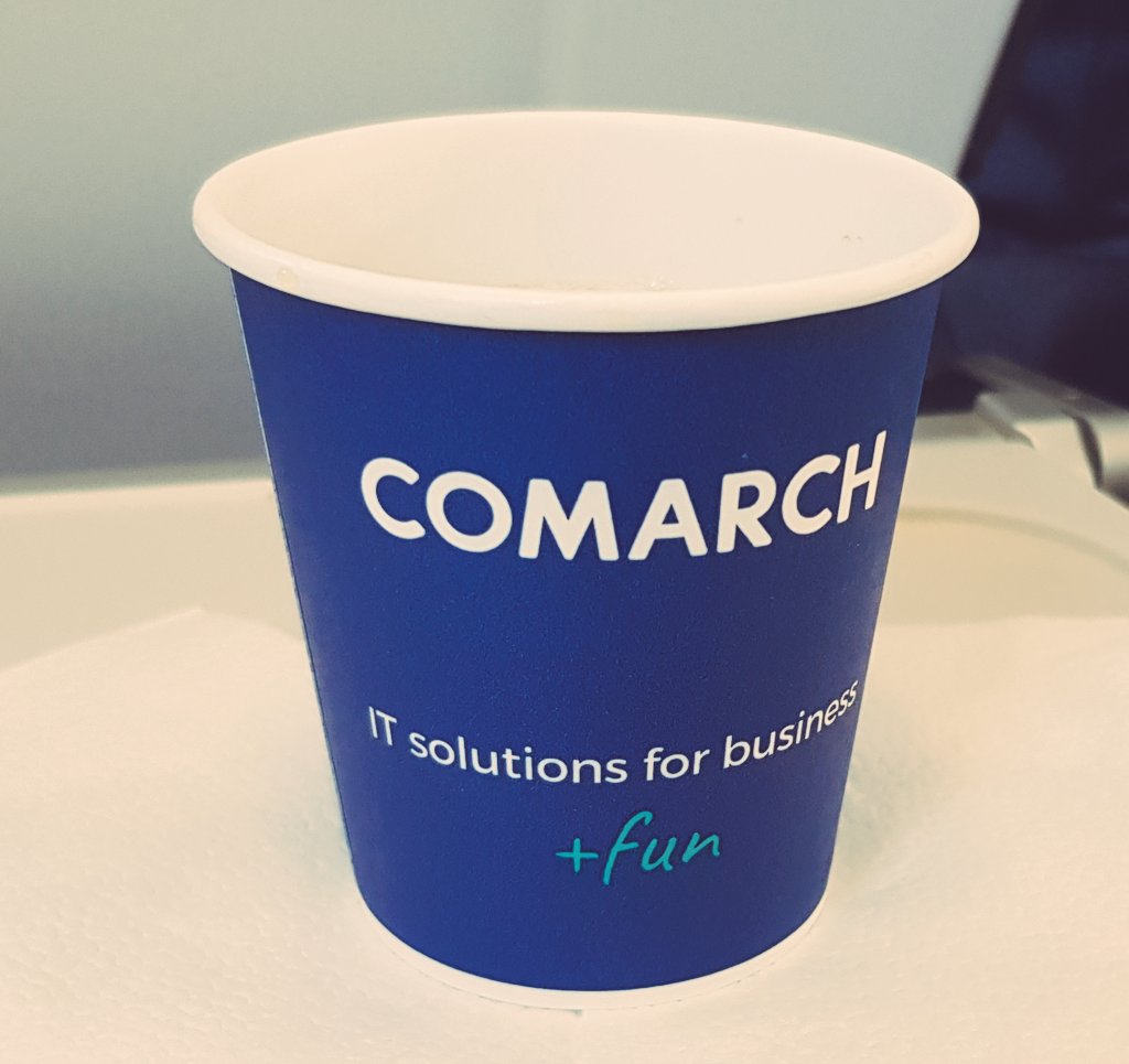 a paper cup in an airplane advertising "IT solutions for business" company
