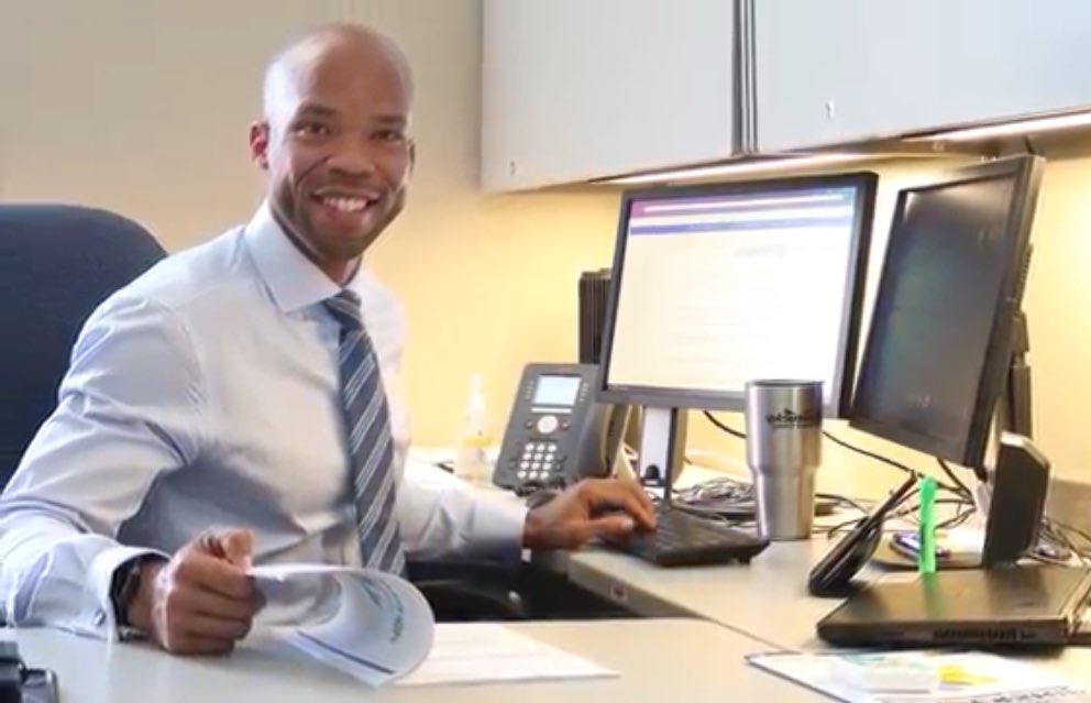 Picture of state employee at his desk