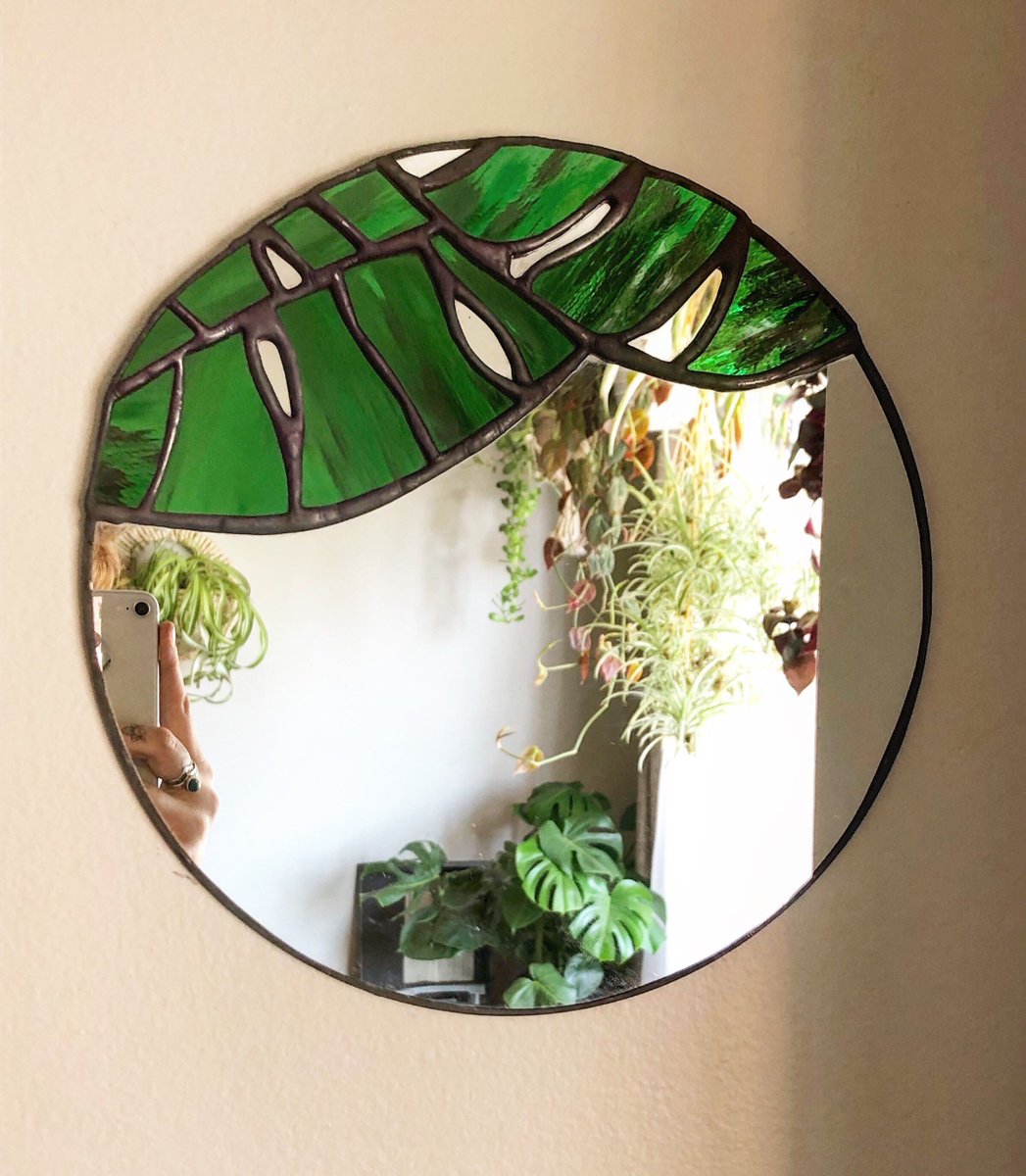 Stained glass + monstera leaves + circular mirrors. 