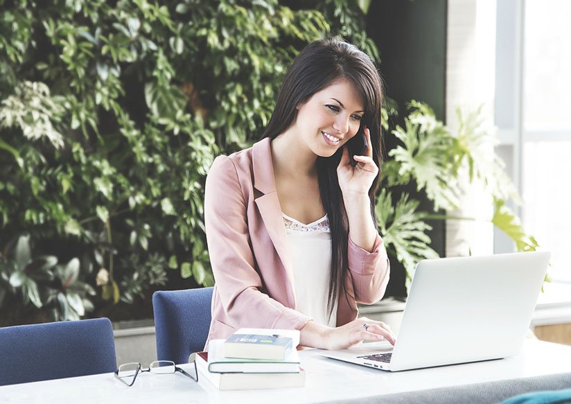 woman smiling on taptop