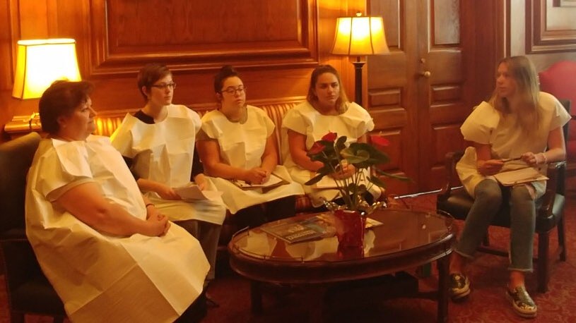 ppgraction's tweet photo. .@GovParsonMO &amp; #MoLeg are trying to “defund” Planned Parenthood &amp; block patients from #birthcontrol, cancer screenings &amp; STI testing. So supporters donned gowns &amp; made his office a waiting room to ask: “How will these patients access vital preventive care?”

#StopTheDefund https://t.co/G8G7sYs9LG