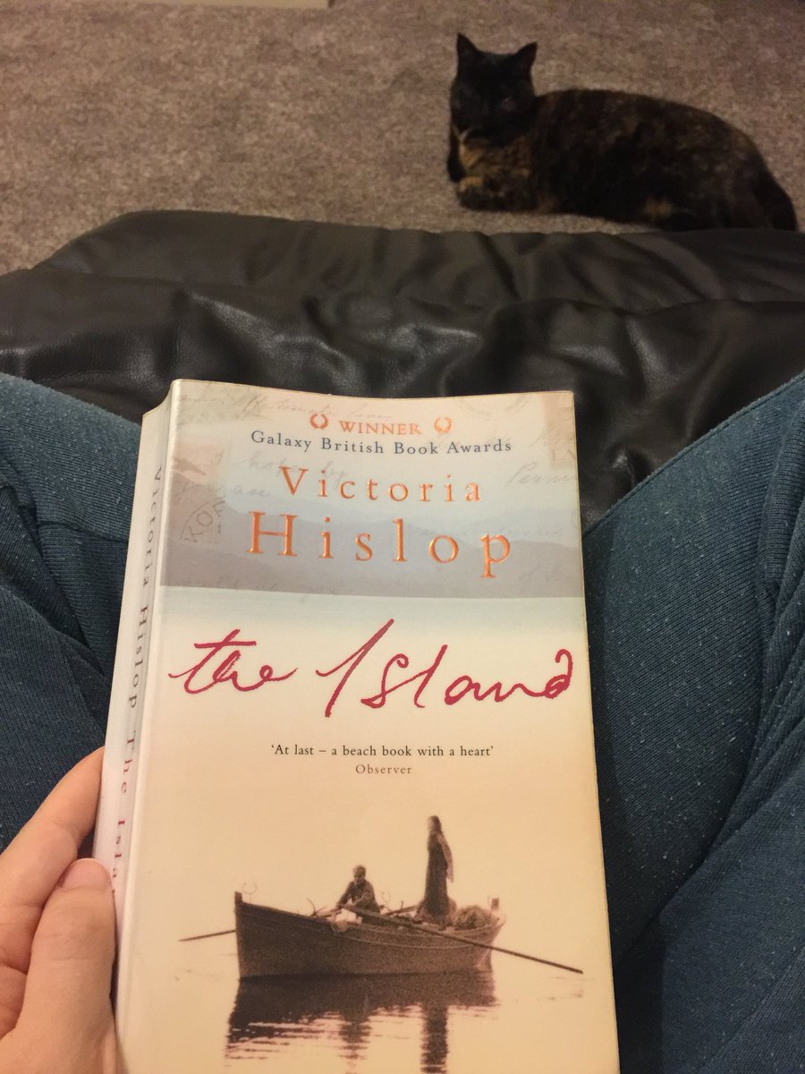 gemsimpkin's tweet photo. Meant to have half an hour reading at 9pm around halfway through Book 20, The Island by Victoria Hislop, but suddenly it’s half past midnight and I couldn’t put the book down! One of my favourites so far! #Lancs50books plus gratuitous cat https://t.co/IKGgzMsbrO