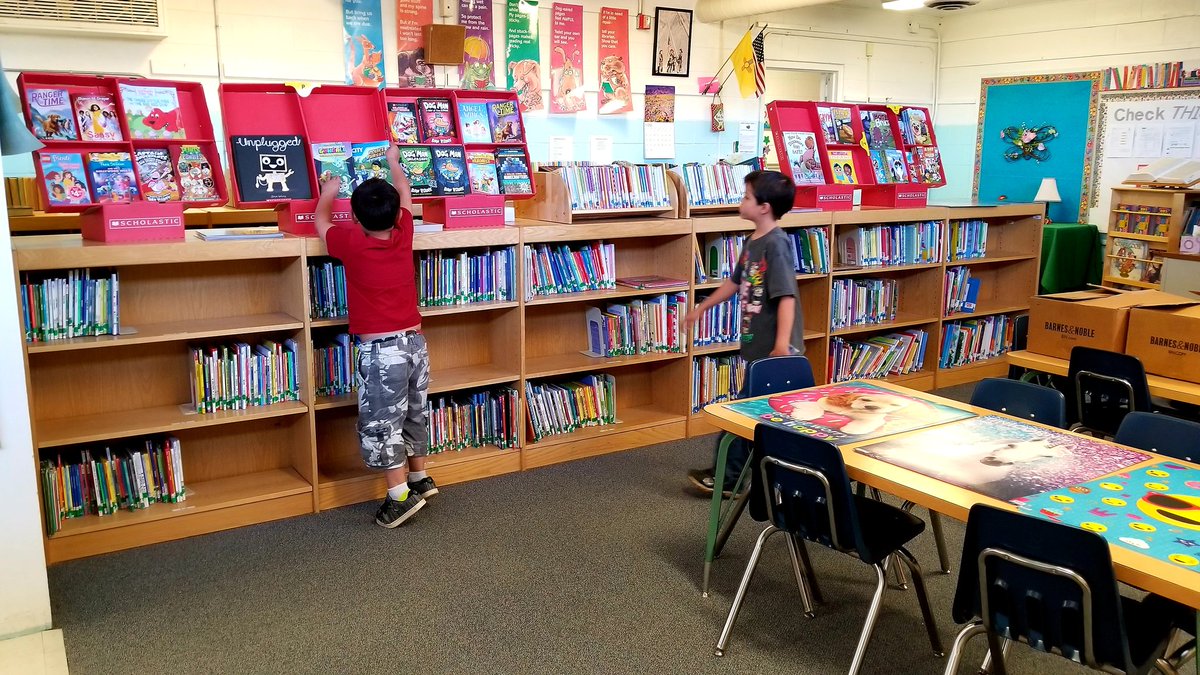 kidsneedtoread's tweet photo. The library at this New Mexico elem school may be humble, but it was hopping with activity, a credit to the librarian &amp; the school's strong emphasis on reading. 2 large boxes on the table were filled with new books delivered by the #PageCoach to help fill up those empty shelves! https://t.co/WlmRyOAT5k