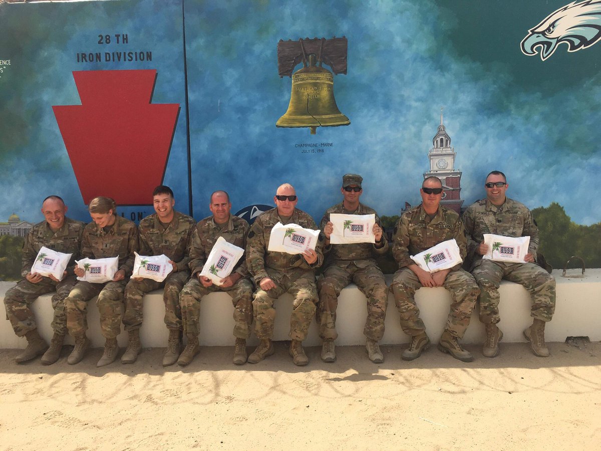 LibertyUSO's tweet photo. Hey @jkjinc1, the care packages your team collected &amp; assembled are arriving downrange! These members of 28th Infantry Div. at Camp Arifjan, Kuwait appreciate their #USO #ChristmasInJuly care packages. These smiling faces are down to you! https://t.co/BZsLOlXKYg