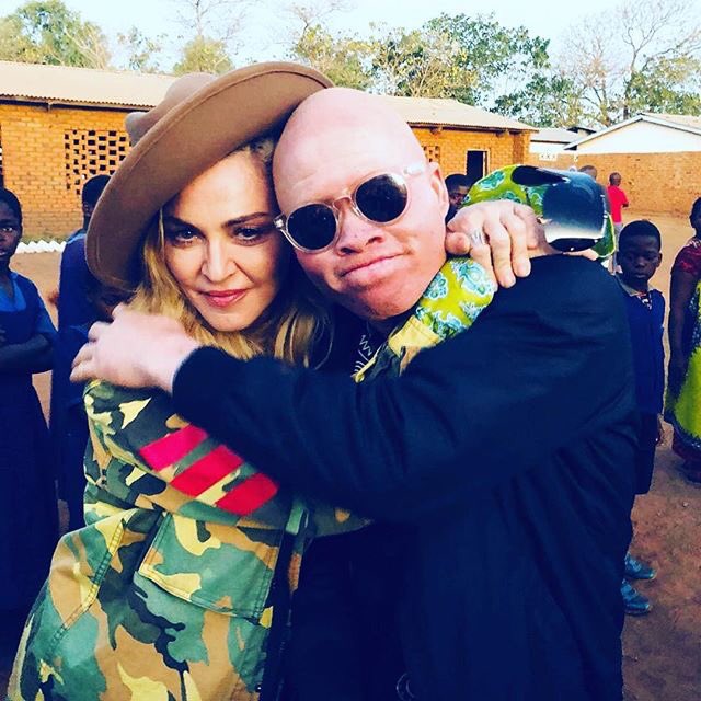 Madonna's tweet photo. With Lazarus, a great singer and musician 🎶🎤🎸 and a powerful voice of a new generation in Malawi, who won’t be silenced because he happened to be born with albinism! 🌍🌏🌎 #globalfamily #revolutionoflove ♥️🇲🇼 #raisingmalawi https://t.co/VTq3hVrjfg