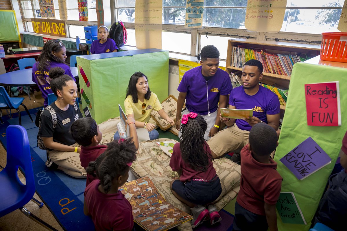 LSU students volunteering in a classroom - reading to children.