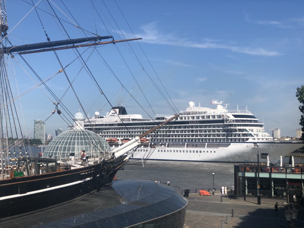 The view from my office window right now. @CuttySark being dwarfed by the @VikingCruisesUK ship!