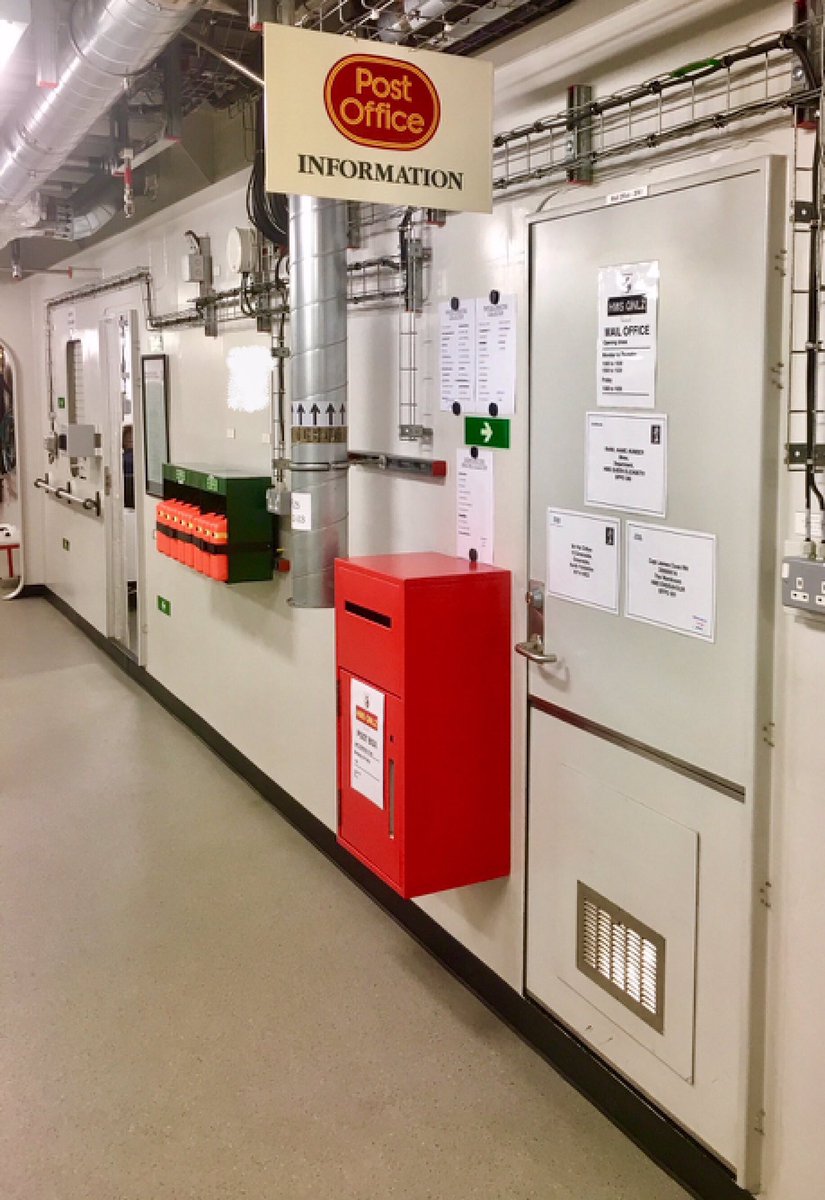 Three Foxtrot passageway which features a standard red post box and a retro post office sign.