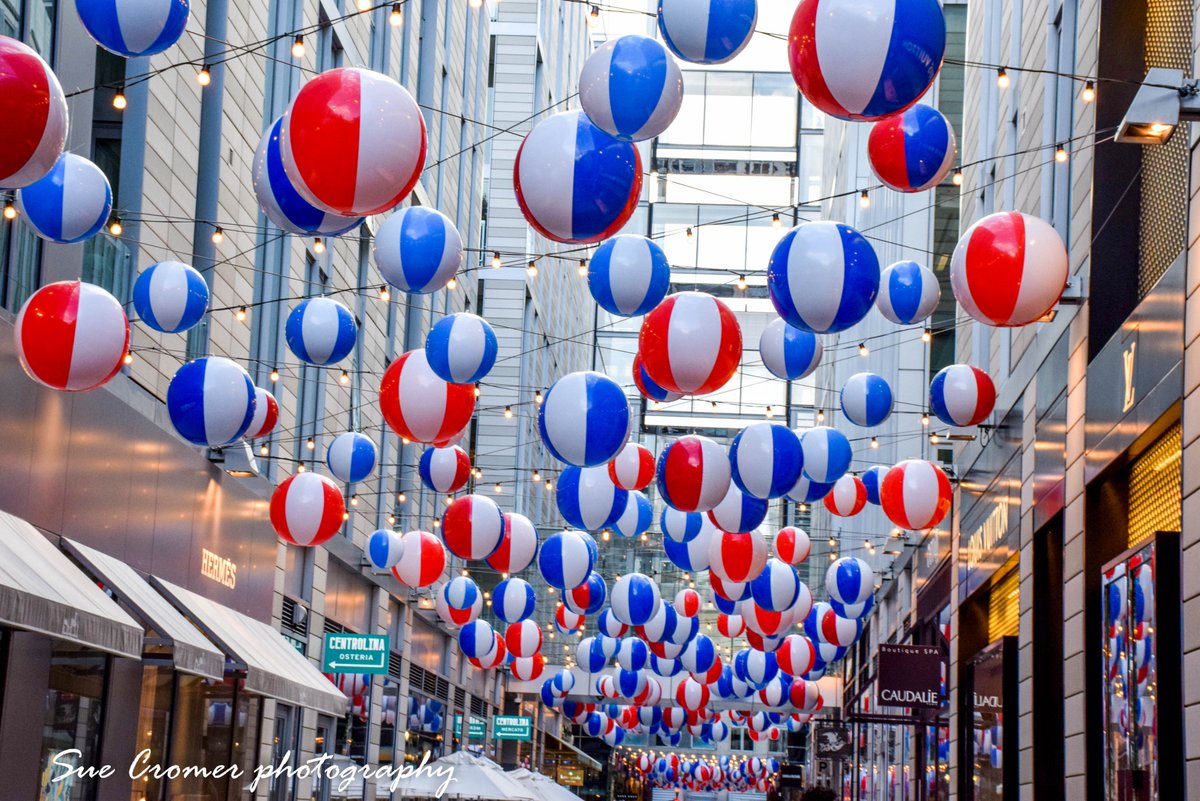SueCromer's tweet photo. On another rainy day, here are some of the beach balls at the City Center DC/DC City Center. (taken on a dry day) #CCDCSummer @capitalweather https://t.co/fHabEuZwbc