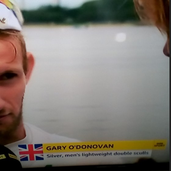 TommyDoc36's tweet photo. BBC sticking Union flags on everything. Here's Irish Rower, Ireland's Gary O'Donovan, getting interviewed after his Silver medal in the Double-Sculls for Ireland.
They zoomed in on his face to cut out Ireland logo on his chest &amp; did the same seconds before with his brother, Paul. https://t.co/p2EYBAj0bv
