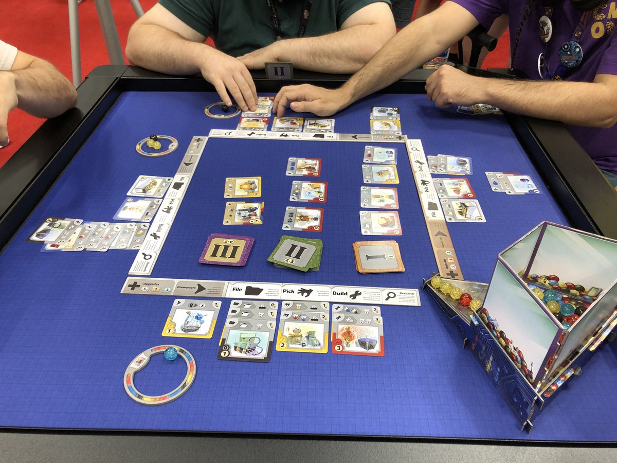 TheToshiStation's tweet photo. Last day of #GenCon2018 demos... this one is Gizmos in the @CMONGames booth. It’s a cool engine building game that makes you design the most efficient method of gaining resources to make a better engine. Will definitely go on the list. https://t.co/huAjYJtQ8h