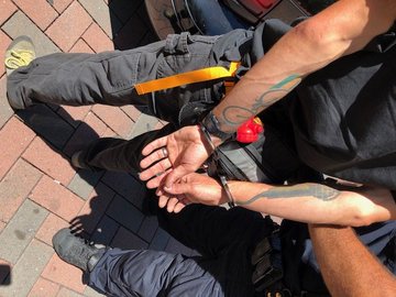 Photo of a man hands in handcuffs.