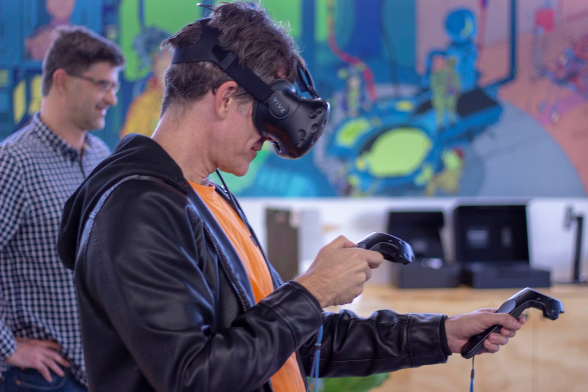JimboPicton's tweet photo. Caloundra State High School Virtual Reality (VR) guru teacher, Adam Baker puts @CQUni Noosa digital media tutor, Stephen Hamacek through his paces at the https://t.co/QeauP0BnSt competition teacher information night at the Peregian Digital Hub. #immersehigh #createnoosa https://t.co/N3PMXIwW3m