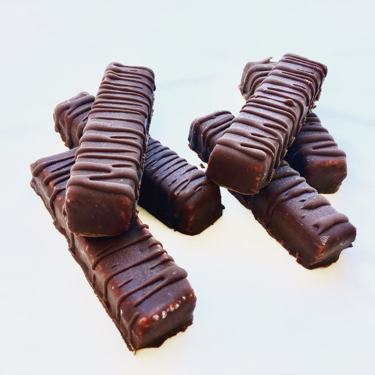 T  W  I  X  BARS .
Say hello to Rawnchy’s brand new TWIX bars! A slab of cashew and coconut, smothered in date and tahini caramel and then encased in our famous chocolate. 
All naturally vegan &amp; FREE FROM gluten, dairy, soy and refined sugar. You can thank us later💁🏼‍♀️😏