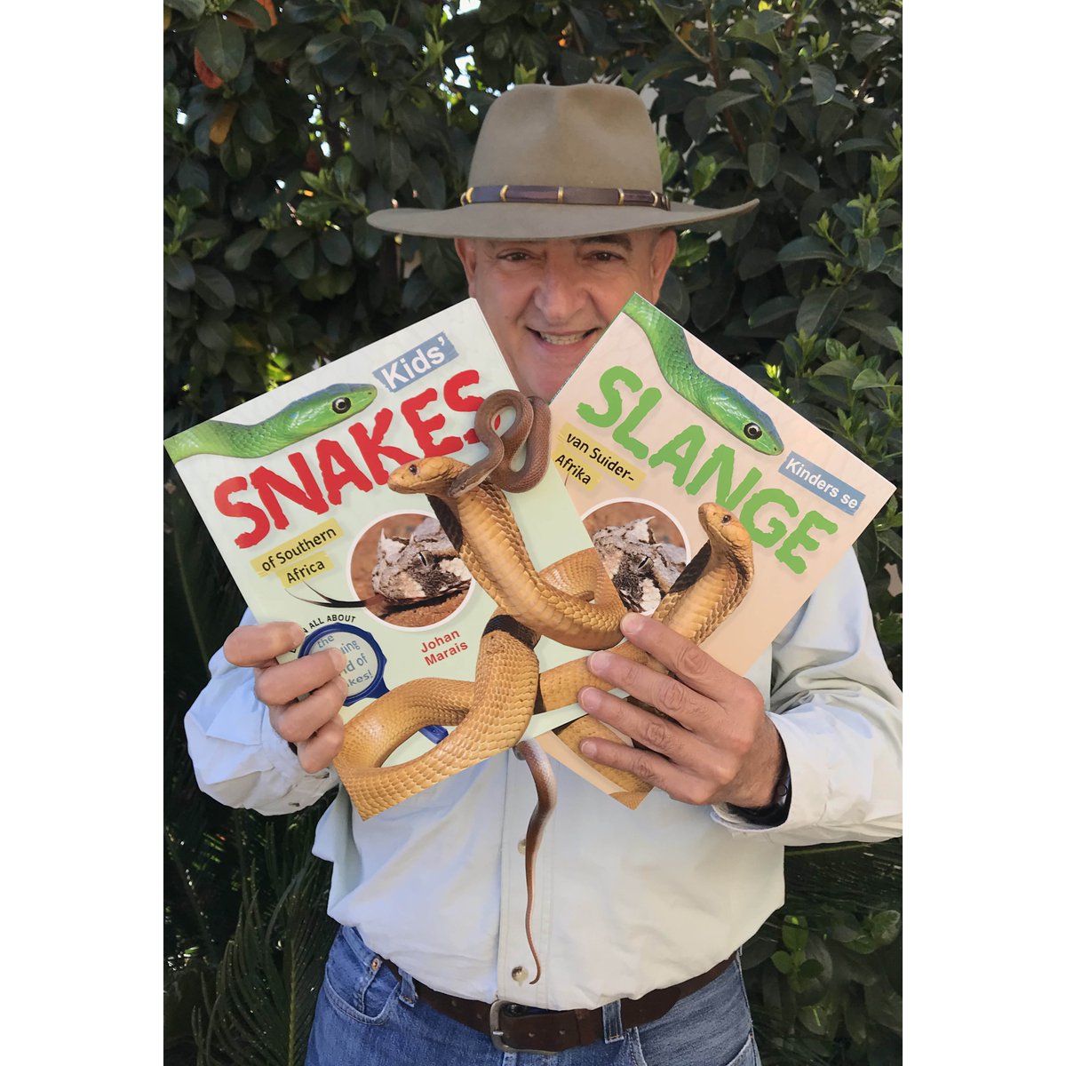 PenguinBooksSA's tweet photo. Snake charmer, author and reptile conservationist Johan Marais (@reptileventures) proudly showing off the advanced copies of his brilliant new book on snakes for kids, out in August! 🐍📚

#africansnakebiteinstitute #snakes https://t.co/a3351UWWN0