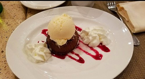 Anyone in the mood for a warm and gooey chocolate lava cake with a big scoop of vanilla ice cream drizzled with raspberry sauce! 
•
Feeding The Neighborhood Families #Since1953.