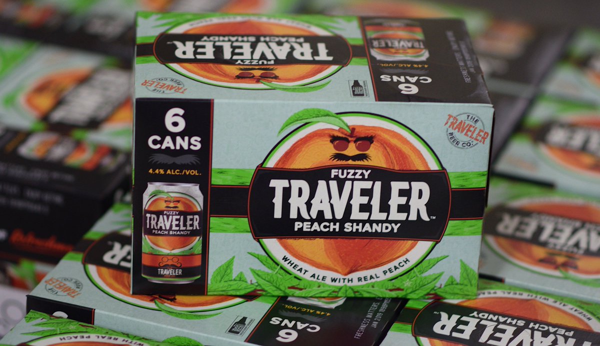 Fuzzy Traveler is a juicy wheat beer made with real peach and a kiss of honey. It delivers everything you love about a shandy, with the perfect pop of peach 🍑 <a href="/TravelerBeer/">Traveler Beer Co.</a>
